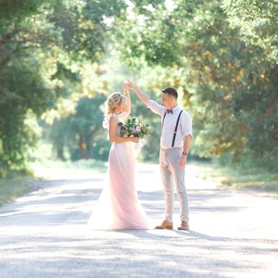 Couple dancing outdoors on a sunny day.