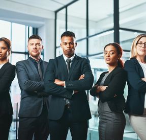Confident business team standing together in office.