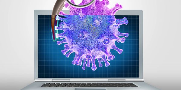 A virus emerging from a laptop screen, symbolizing cyber threats.