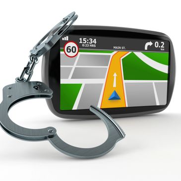 GPS device with handcuffs symbolizing driving restrictions.