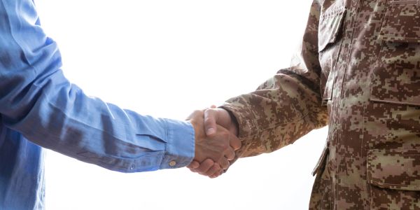 Handshake between civilian and soldier.