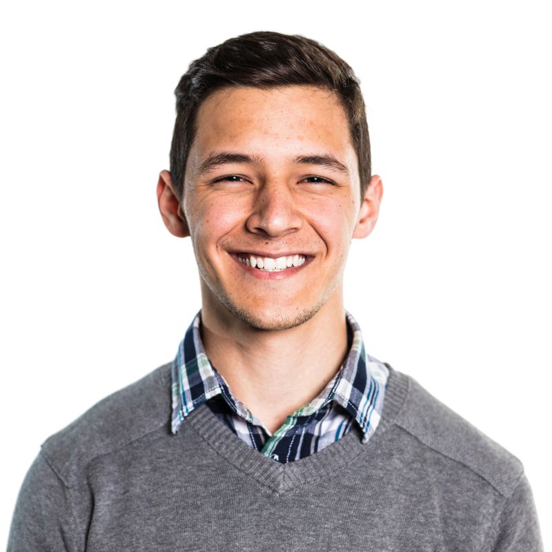 Portrait of cheerful young man. Close-up of smiling male is wearing sweater. He is against white background.