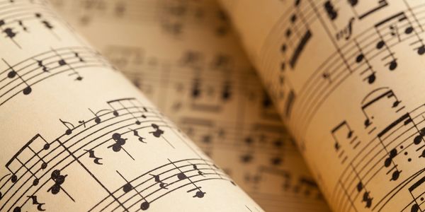 Close-up of vintage sheet music with musical notes and staffs.