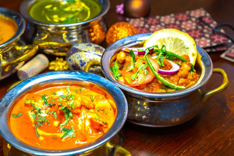 indian food . Dishes and appetizers of indian cuisine. Curry, butter chicken, rice, lentils, paneer, samosa, naan, chutney, spices. Bowls and plates with indian food assorted
