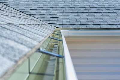 Close-up of roof shingles and gutter system.
