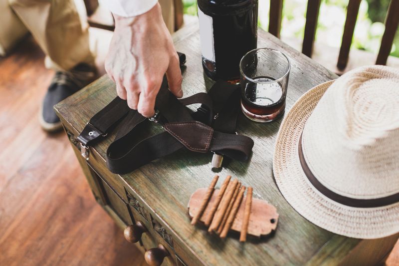 Male set: cigars, whiskey, hat, suspenders on vintage a wooden table