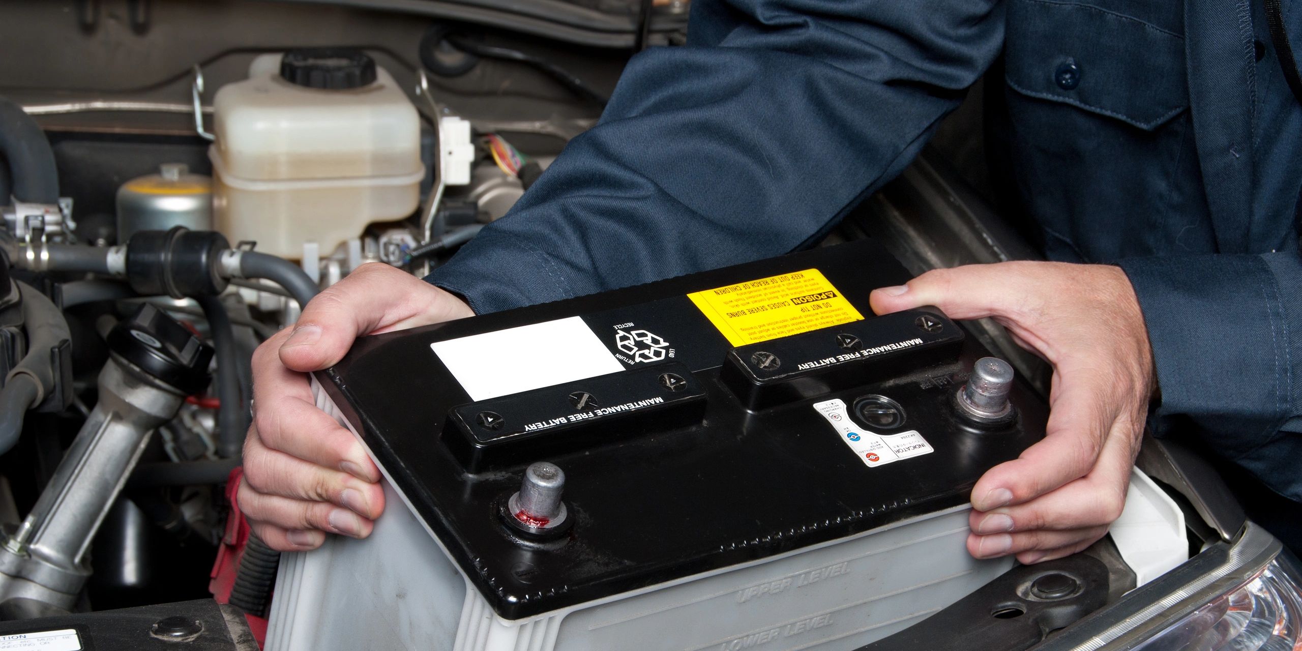 Mobile battery service installing car battery with on-site testing and replacement