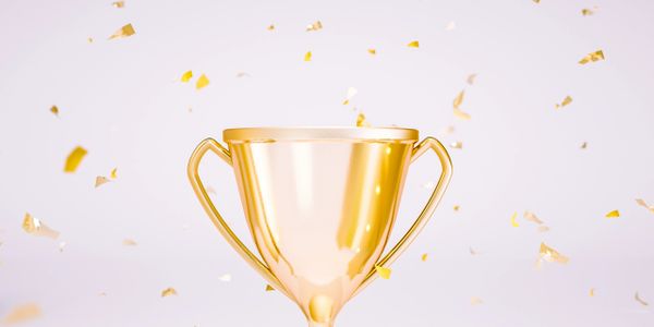 Golden trophy with confetti celebrating a victory.