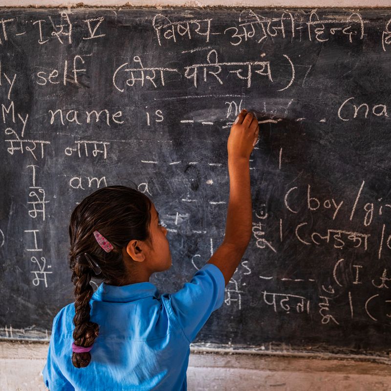 Indian schoolgirl in classroom, English language class, Rajasthan, India