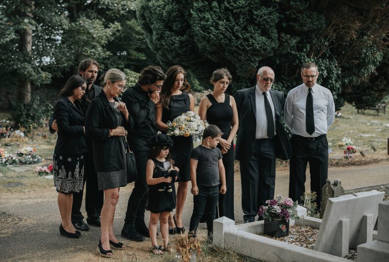 Family giving their last goodbyes at the cemetery