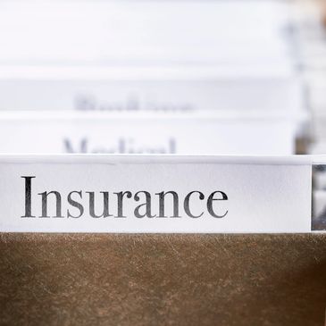 Close-up of an insurance file tab in a brown folder.