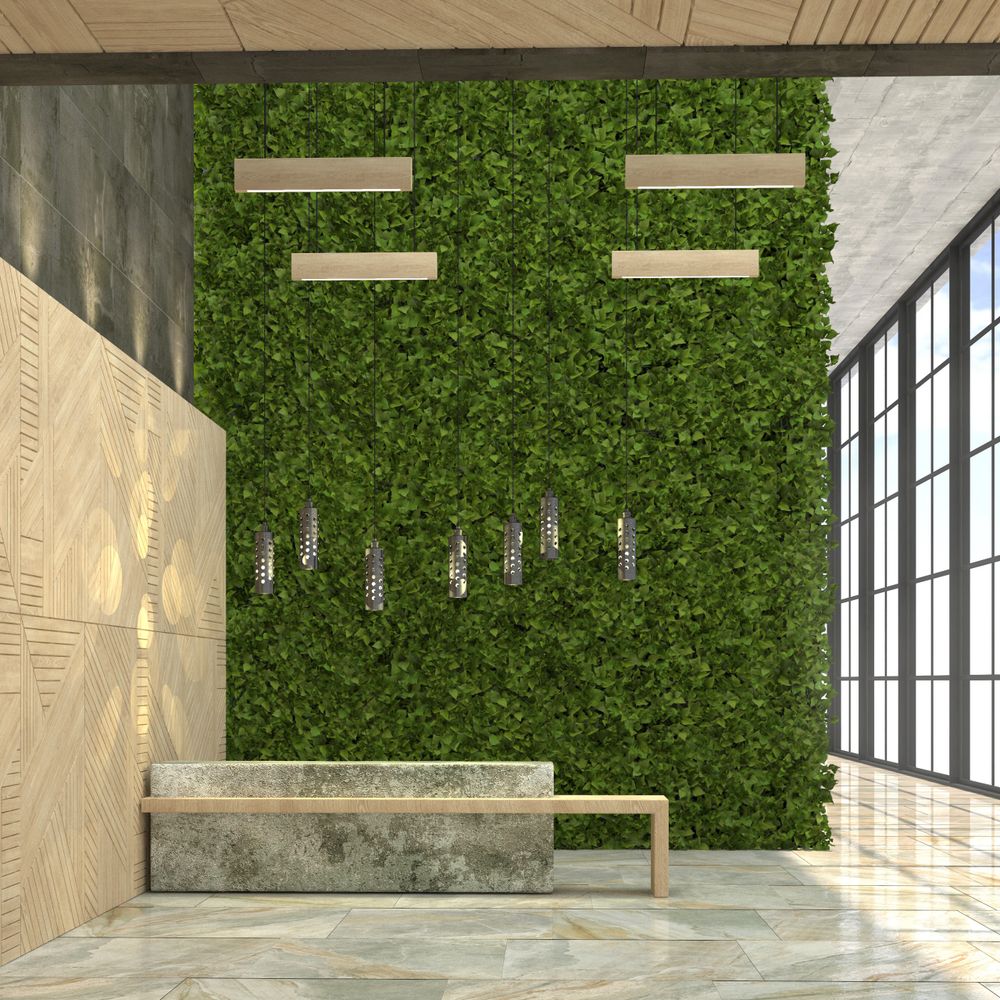 Modern interior with green plant wall and concrete bench under pendant lights.