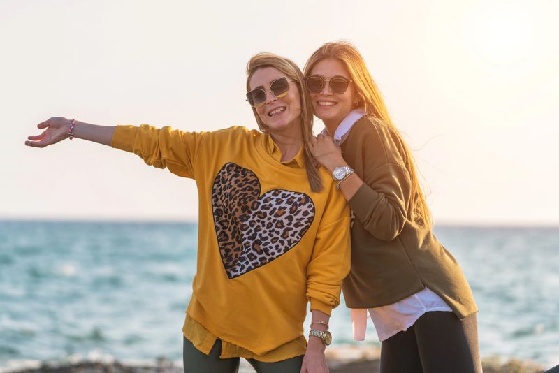 Two happy women having fun by the sea