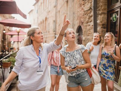Professional tour guide leading an organized group through a historic Middle Eastern city program