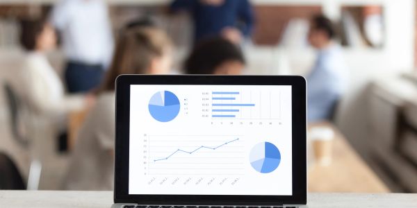 Laptop displaying business charts in a meeting room.