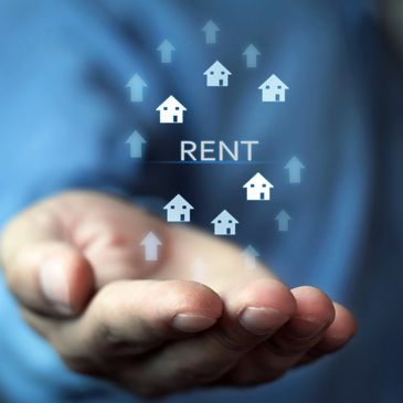 Hand holding virtual icons of houses and upward arrows with the word RENT.