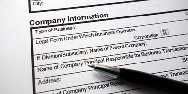 Pen pointing at company information form.