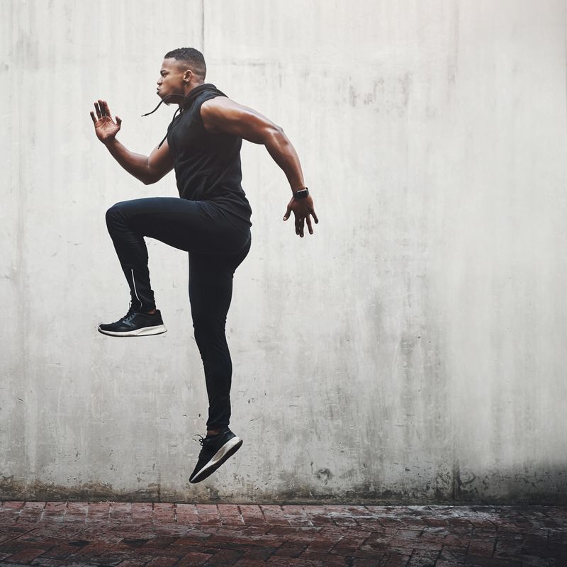 Full length shot of a handsome young man skipping on the spot while exercising outside