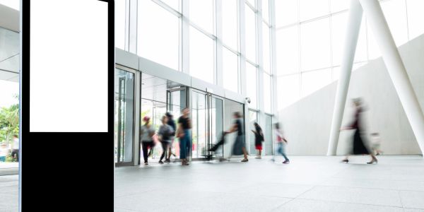 Blurry people walking in a spacious modern building.