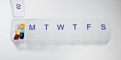 Weekly pill organizer with capsules and tablets.