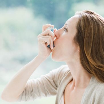 Lady using her asthma inhaler 