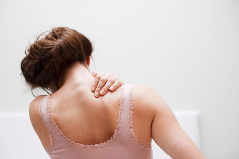 Woman rubbing aching back