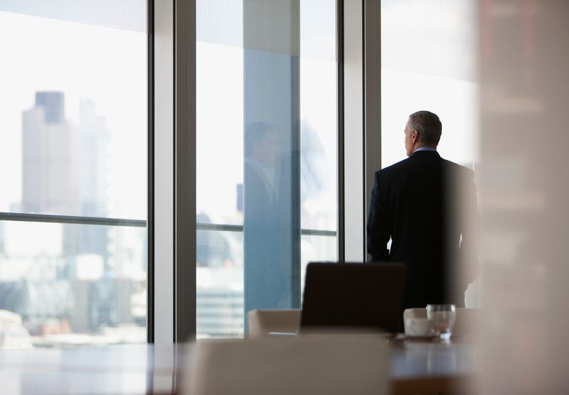 Businessman looking out conference room window