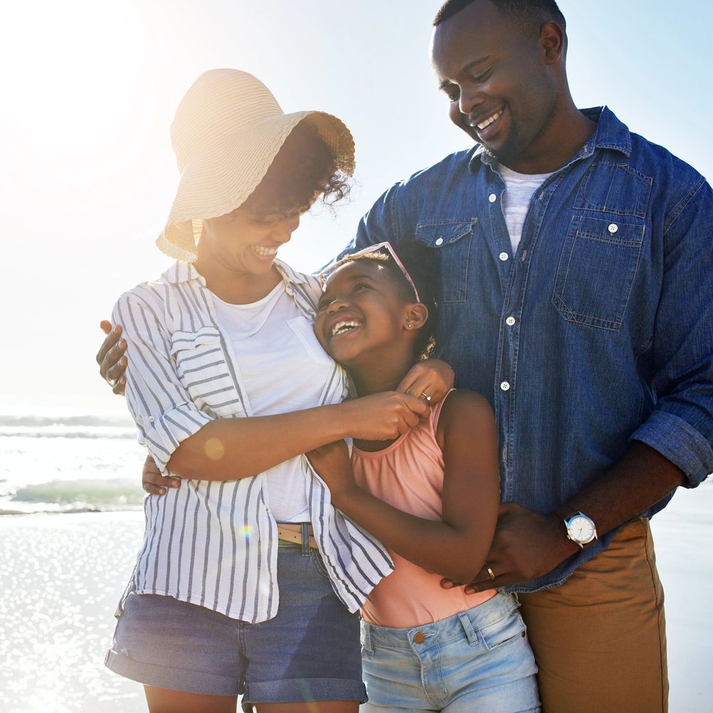 Happy family enjoying a sunny day at the beach together.