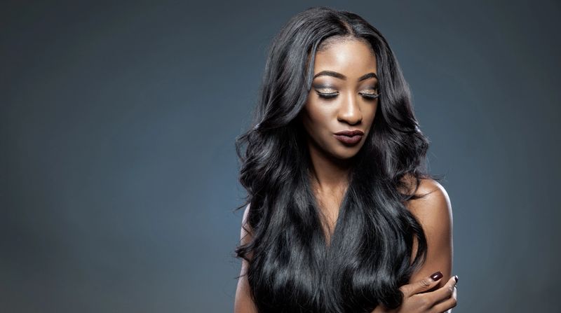 Black beautiful woman with long luxurious shiny hair