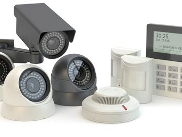 Home security system with cameras, motion sensors, smoke detector, and control panel.