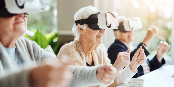 Elderly people enjoying virtual reality experience.