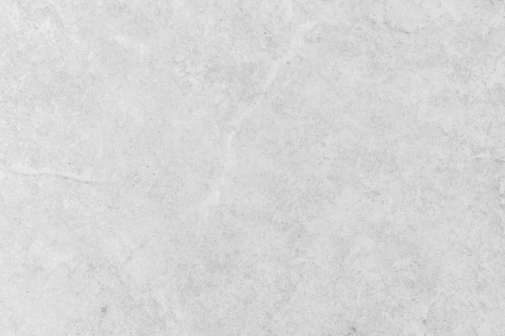 Gray concrete wall with subtle texture and faint stains.