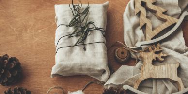 Rustic holiday gift with wooden ornaments and twine.