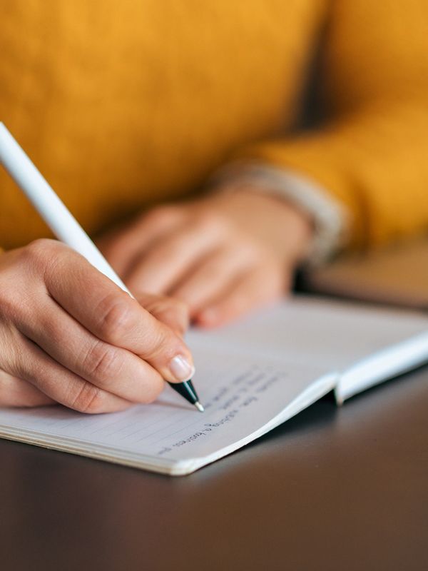 a woman writing in a book