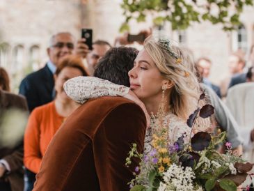 Emotionally hugging at a wedding ceremony.
