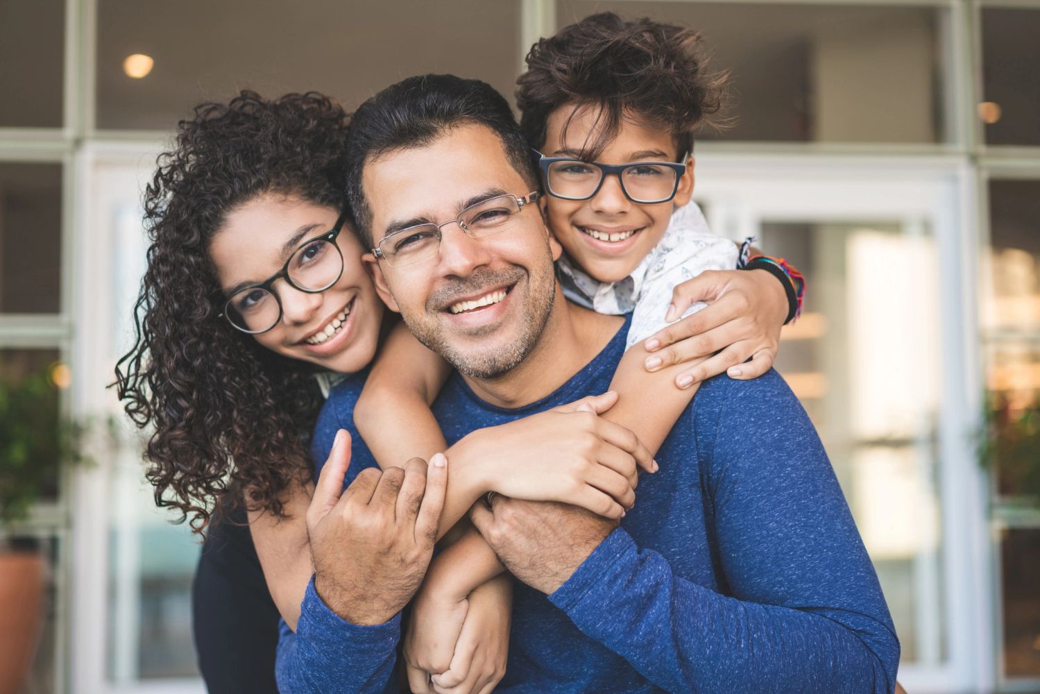 Happy family embracing and smiling together indoors.