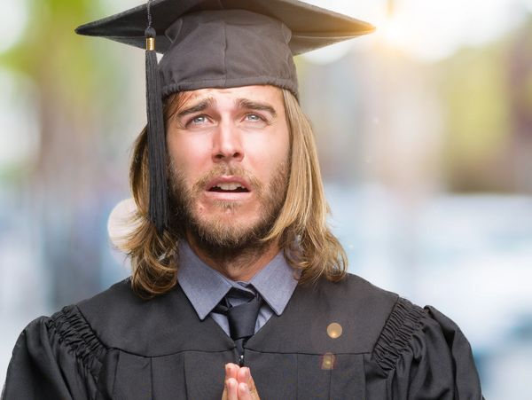 Graduation student looking hopeful and praying.