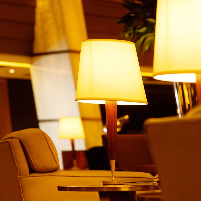 Table lamp illuminated in living room by sofa