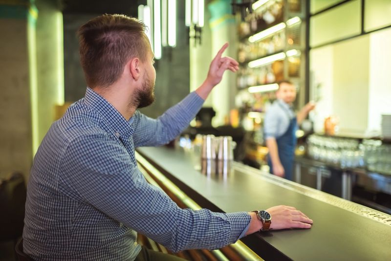 The man makes an order at the bar