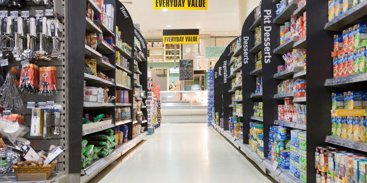 A supermarket aisle stocked with various food and kitchen items under 'Everyday Value' signs.