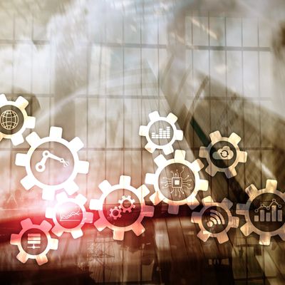 Abstract gears with technology and data icons overlaying industrial background.