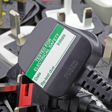 Black electrical plug with safety testing label.