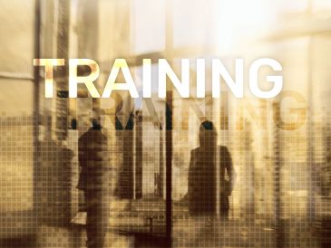 Silhouettes of businesspeople with 'TRAINING' text overlay in an office setting.
