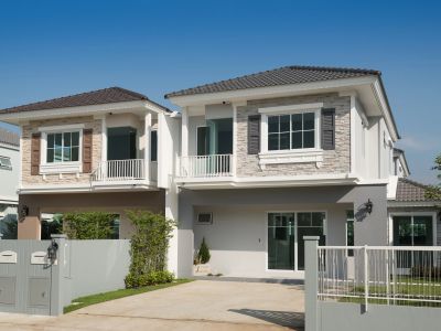 Modern two-story house with gated driveway.