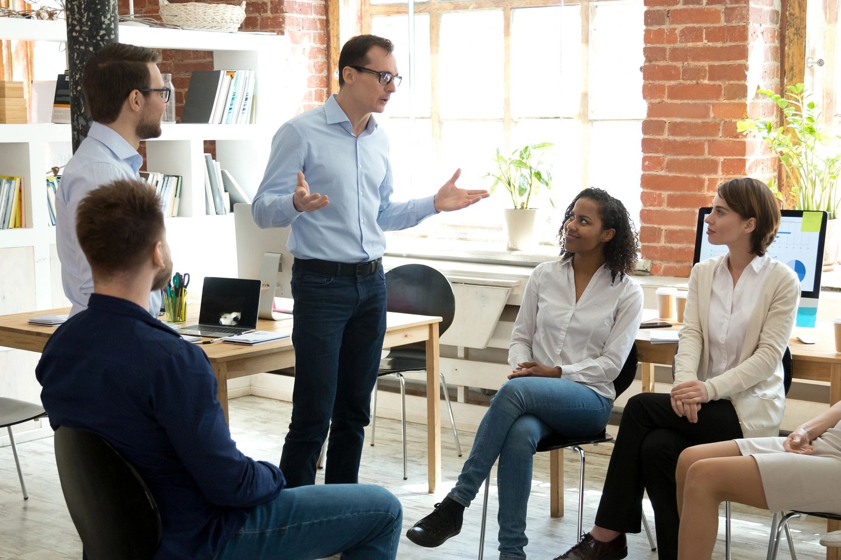 Instructor leads a training session, engaging a group of employees in workplace safety strategies.
