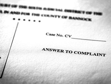 Close-up of a legal document titled "Answer to Complaint."