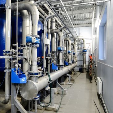Industrial pipes and machinery in a clean facility.