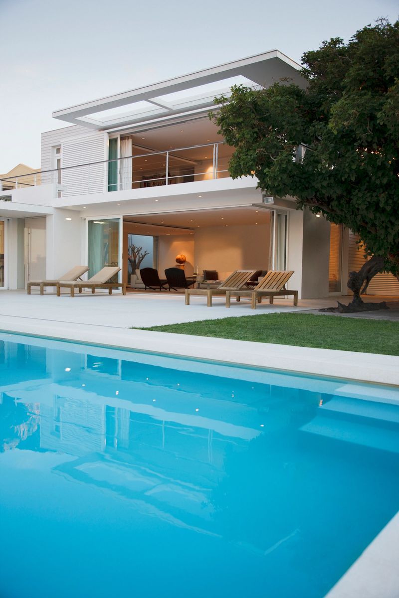 Modern house and patio next to swimming pool