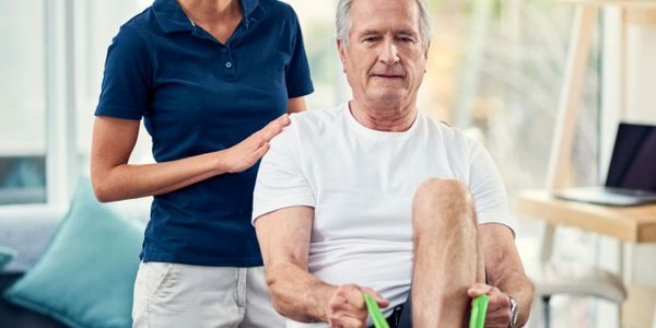 Physical therapist assisting elderly man with leg exercises using a resistance band.
Compassionate nursing, personalized rehabilitation, senior care