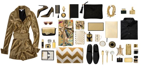Flat lay of gold and black fashion and accessory items.